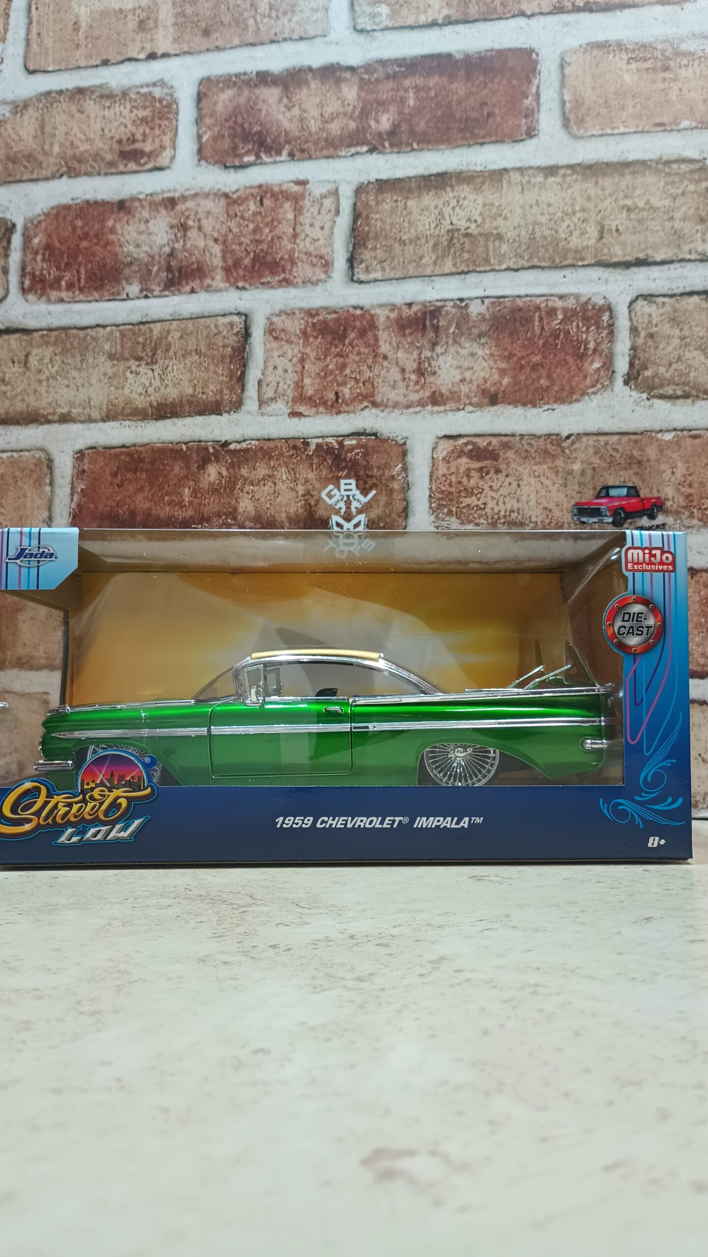 1959 Chevrolet Impala Lowrider Green Metallic with Cream Top and DUB Wire Wheels "Street Low" Series die cast by Jada.