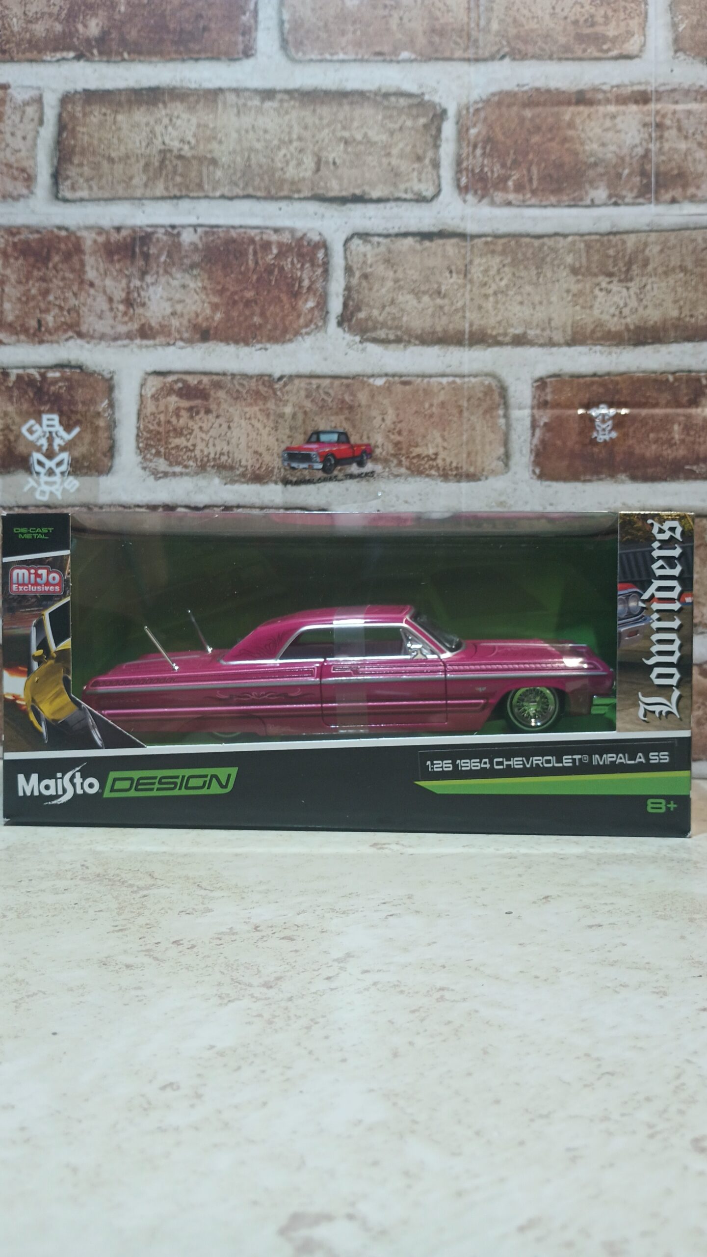 Brand new 1/26 scale diecast car model of 1964 Chevrolet Impala SS Lowrider PINK Graphics "Lowriders" "Maisto Design" Series die cast model car by Maisto